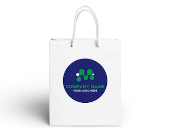 May include: A white paper shopping bag with two white cord handles. Centered on the bag is a dark blue circle containing a green abstract letter M logo with two small white dots, and the text COMPANY NAME and YOUR LOGO HERE in green and white.