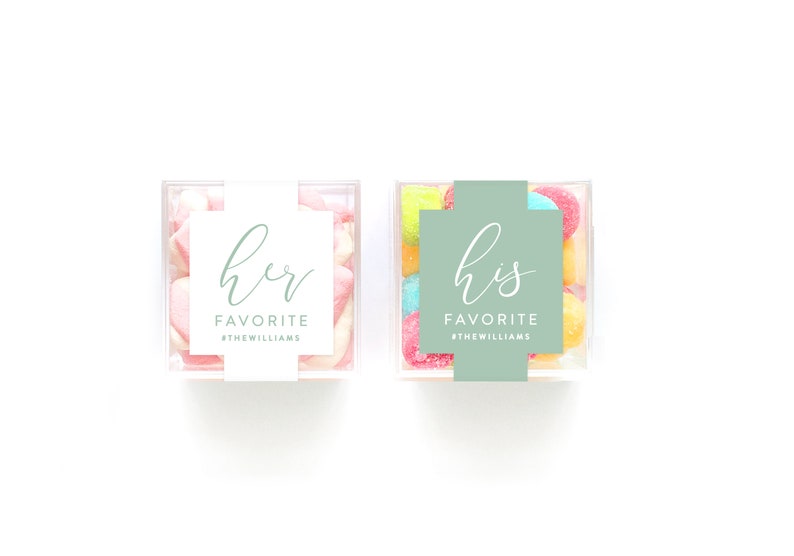 May include: Two clear plastic containers filled with colorful candies. One container has a white label with the text "her favorite #thewilliams" and the other container has a green label with the text "his favorite #thewilliams".