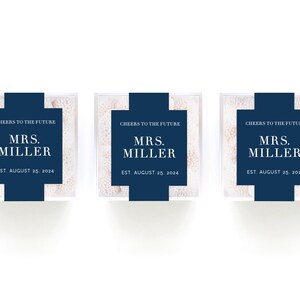 May include: Three clear favor boxes filled with white candy. Each box has a blue label with the text "Cheers to the Future", "Mrs. Miller", and "Est. August 25, 2024".