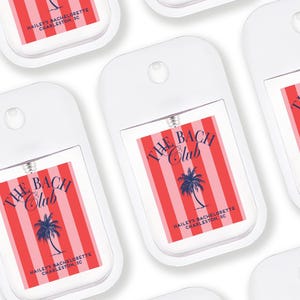 multiple identical white spray bottles with red and blue labels, each featuring the text "THE BACH CLUB" and "HAIL'S BACCHETTE CHARLESTON SC" printed on them.