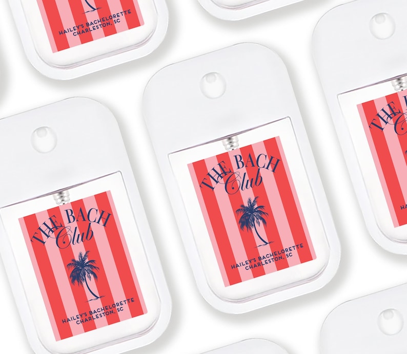 multiple identical white spray bottles with red and blue labels, each featuring the text "THE BACH CLUB" and "HAIL'S BACCHETTE CHARLESTON SC" printed on them.