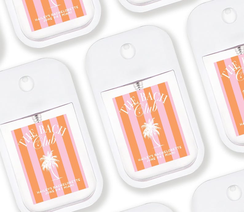 multiple identical white spray bottles with orange and pink striped labels, each featuring the text "THE BACH CLUB" and "HAILES BACHELETTE JUNE 5-8 MIAMI".