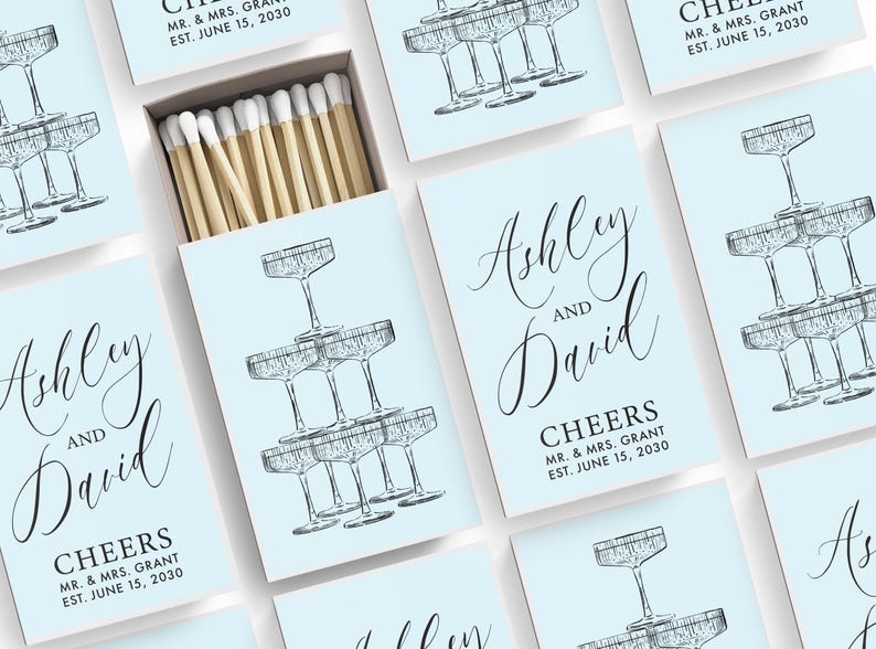 a collection of light blue cards with illustrations of champagne glasses and text that reads "Ashley and David". The cards are arranged in a grid-like pattern, with some cards overlapping each other.