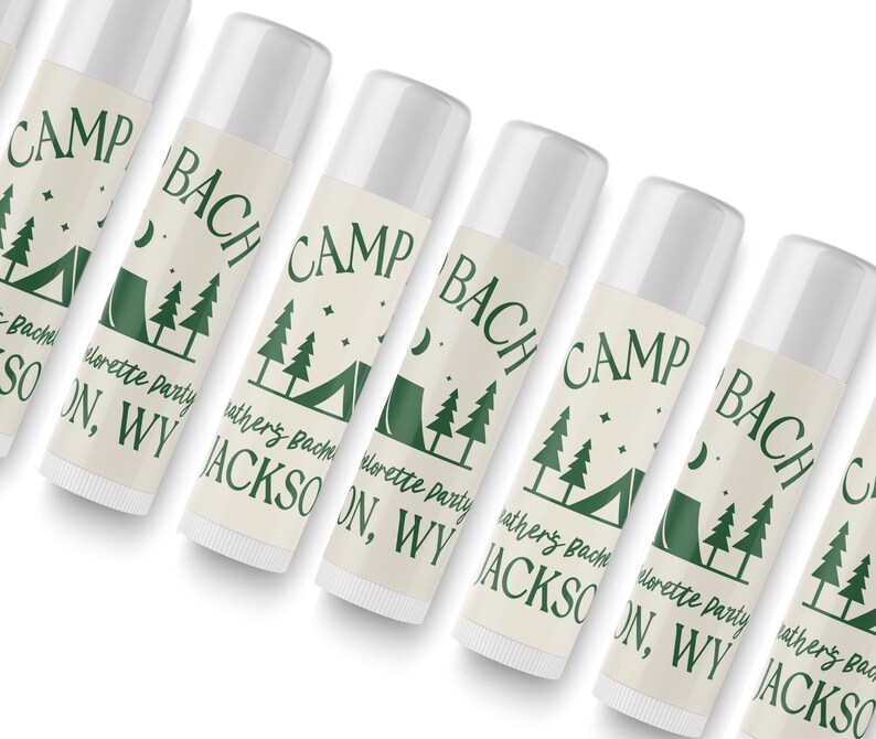 May include: Six white tubes with green and black labels. The labels have the text "CAMP BACH" and "elorette Party" with a camping tent and trees graphic.