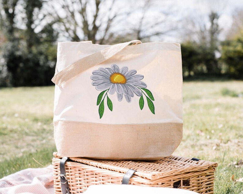 Daisy embroidery design featured on a shopping bag.