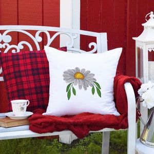 Daisy embroidery design featured on acushion.