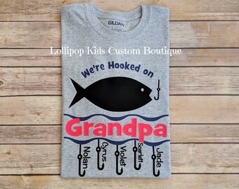 Fishing, fisherman. We're hooked on Daddy, Abuelo, Poppy, Etc. Short sleeve Shirt*