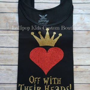 May include: Black tank top with a gold glitter crown and red glitter heart. The text "Off with their heads!" is written in gold glitter below the heart.