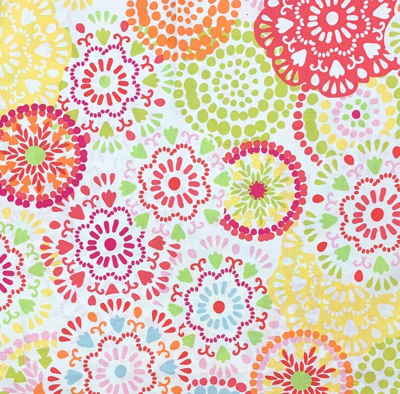 May include: A white background is covered with a repeating pattern of colorful, circular floral designs. The flowers are in shades of red, pink, orange, yellow, green, and blue. The design is reminiscent of a textile or fabric.