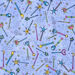 May include: A light blue fabric with a repeating pattern of colorful magic wands, stars, and swirls. The wands feature heart, star, and gem designs in pink, yellow, blue, and green. The design includes small stars and dotted lines.