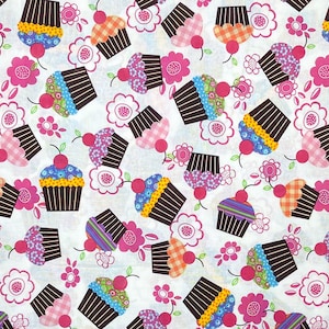 May include: A repeating pattern of cupcakes and flowers on a white background. The cupcakes have brown liners and colorful frosting, topped with a cherry. Pink flowers with white centers are scattered throughout the design.