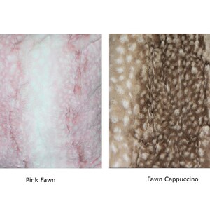 May include: Two faux fur throw pillows, one in pink with white spots and one in brown with white spots. The pillows are labeled "Pink Fawn" and "Fawn Cappuccino".