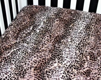 May include: A brown and black leopard print blanket with a soft, fuzzy texture.