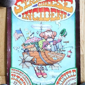Könnte beinhalten: Ein Vintage-Konzertplakat für "The String Cheese Incident" im Warfield in San Francisco am Freitag und Samstag, 17. und 18. März. Das Plakat zeigt eine Cartoon-Illustration eines Mannes in einem Boot mit einer Ente, einer Flagge und einem Koffer.