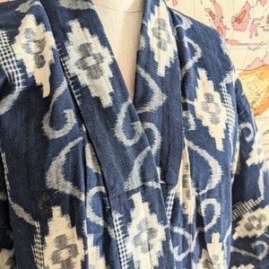 May include: A blue and white patterned kimono with a traditional Japanese design. The kimono is made of a soft, lightweight fabric and has a relaxed fit.