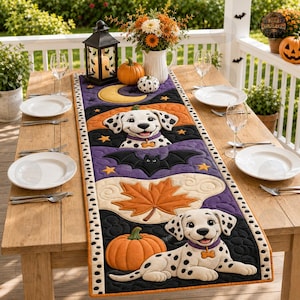 May include: A rectangular quilted table runner featuring a Halloween theme with two dalmatian puppies, orange pumpkins, a yellow crescent moon, a black bat, and orange maple leaves on a purple and black background with a white polka dot border.