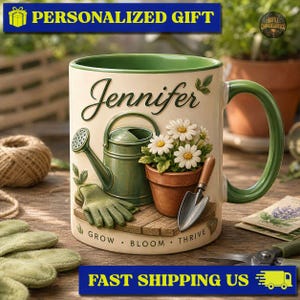 May include: A cream-colored ceramic mug with a green handle and interior, featuring the name Jennifer in script, a green watering can, a terracotta pot with white daisies, a trowel, and gardening gloves, with the text GROW BLOOM THRIVE.