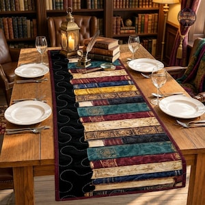 May include: A rectangular table runner featuring a printed pattern of stacked antique books in various colors including red, blue, yellow, and green, set against a black background with a wavy quilted stitch design and a dark red border trim.