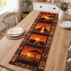 May include: A rectangular table runner featuring a repeating pattern of African wildlife silhouettes, including elephants, giraffes, and zebras, set against a vibrant orange sunset background with acacia trees and a geometric border design.