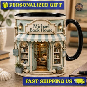 May include: A ceramic mug shaped like a bookstore with a black handle and interior. The facade features a light blue striped awning, two arched windows with shelves of books, and a sign above the door that reads Michael Book House.