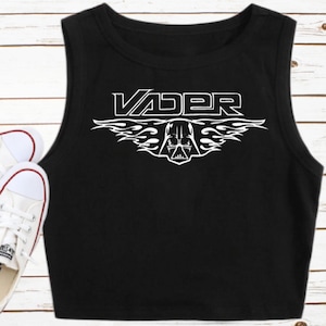 May include: Black sleeveless crop top with a white graphic of Darth Vader's helmet with flames and the word "VADER" above it.