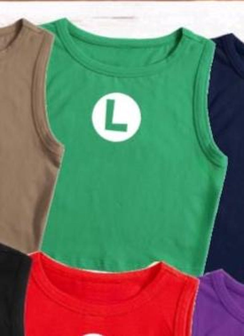 May include: A green tank top with a white circle and a large white "L" on the front. Other tank tops in various colors, including brown, red, and navy blue, are partially visible.