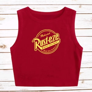 May include: A white ceramic mug with a black handle and the text "But First, Coffee" in a handwritten style. The mug is on a white surface. The mug is approximately 4 inches tall.