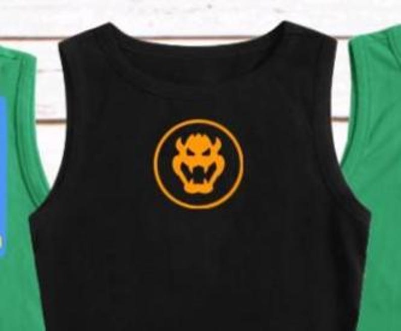 May include: Black tank top with a round orange Bowser logo. The sleeveless shirt has a crew neck and is centered in the image. Two other tank tops, one green and one blue, are partially visible on either side of the black shirt.
