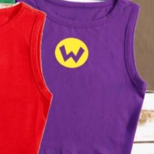 May include: Purple sleeveless shirt with a yellow "W" emblem. The shirt is made of a soft material and is a vibrant color. Other colored shirts are visible in the background.