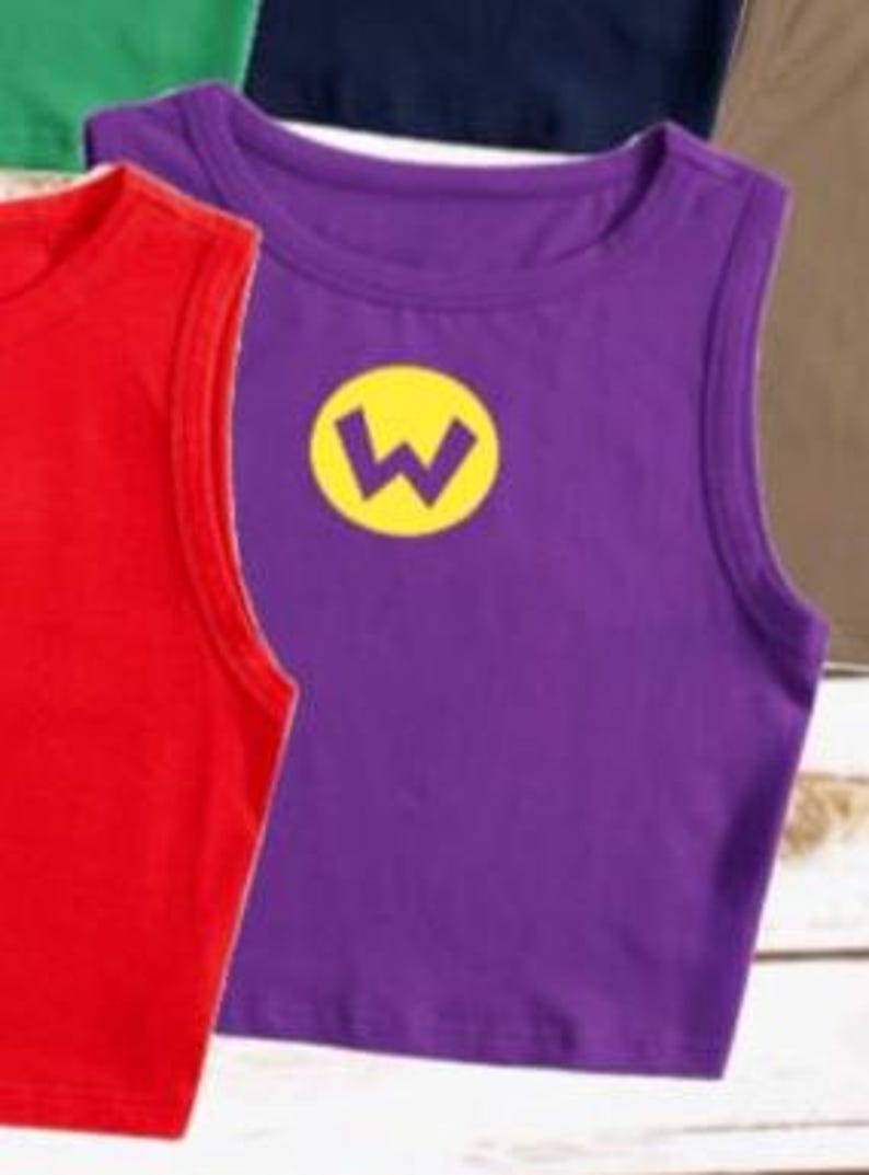 May include: Purple sleeveless shirt with a yellow "W" emblem. The shirt is made of a soft material and is a vibrant color. Other colored shirts are visible in the background.