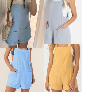 May include: A collection of four sleeveless rompers featuring a square neckline, wide shoulder straps, and two large front patch pockets. The garments are shown in light blue, soft grey, bright blue, and mustard yellow, each with a relaxed fit.