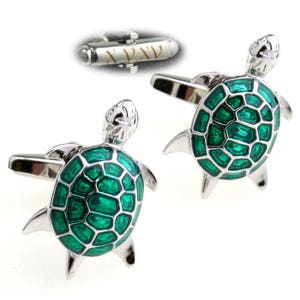 May include: A pair of silver cufflinks with a green enamel turtle design. The turtles have a detailed shell pattern and are a popular choice for men's fashion accessories.