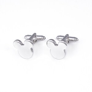 May include: A pair of silver cufflinks with a Mickey Mouse head design.