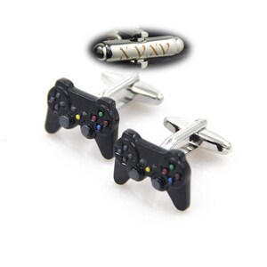 May include: A pair of silver cufflinks with black video game controller designs. The controllers have colorful buttons.