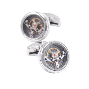 May include: A pair of silver cufflinks with a circular design. Each cufflink features a visible watch mechanism with blue and gold accents.