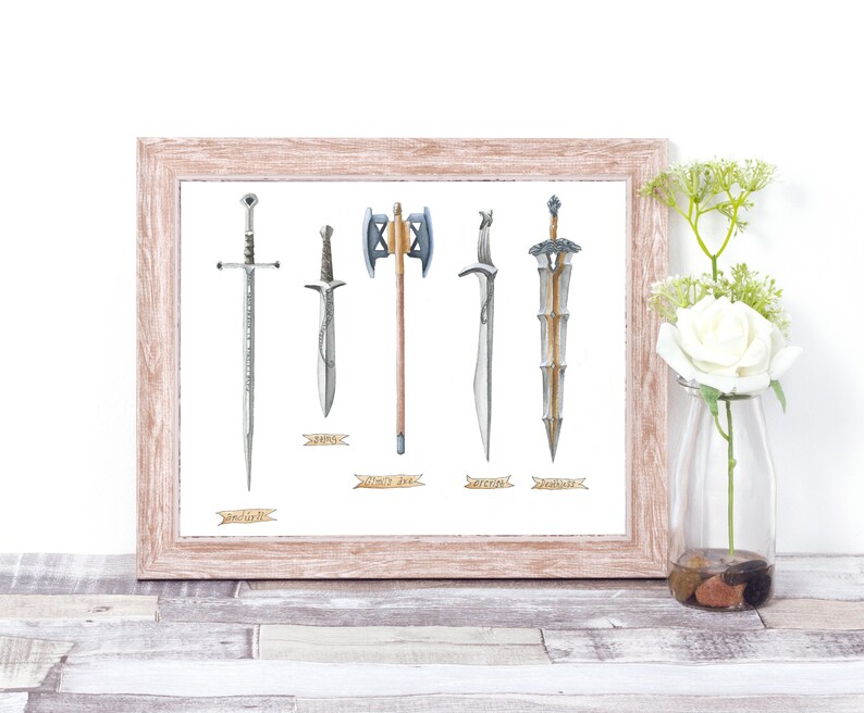 May include: A framed print featuring watercolor illustrations of five different swords and axes. The weapons are displayed against a white background, with a light brown wooden frame. Each weapon has a name written below it on a banner.