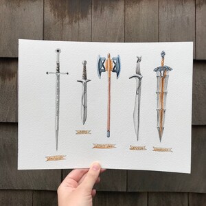 May include: Watercolor painting of five fantasy weapons: a sword, a dagger, a double-bladed axe, a curved sword, and a broadsword. Each weapon is detailed with silver and gold accents. The names of the weapons are written below them.