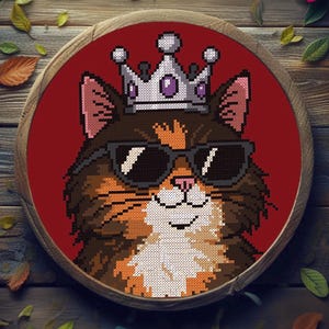 May include: A cross-stitch of a cat wearing sunglasses and a crown, displayed in a wooden embroidery hoop. The cat has brown, orange, and white fur. The background is red, and the hoop is surrounded by leaves and flower petals.