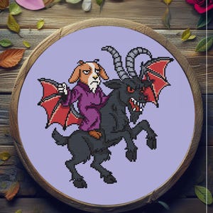 May include: A cross-stitch embroidery featuring a dog-like creature riding a black goat with red bat wings. The dog wears a purple robe. The artwork is set in a wooden embroidery hoop with a lavender background, surrounded by leaves and a rose.