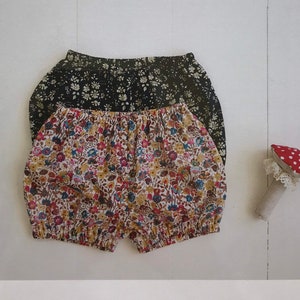 May include: A sewing pattern package for baby and toddler bloomers and pants. The package features two pairs of bloomers, one black with white floral print and one with a colorful floral pattern. The brand name "WIKSTEN" is printed at the top.