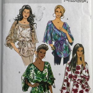 May include: Butterick B5355 sewing pattern envelope for tops in size Y (Xsm-Sml-Med). The illustration displays four variations of loose-fitting tops with tie-waist details, featuring diverse floral and abstract prints in green, purple, and white.