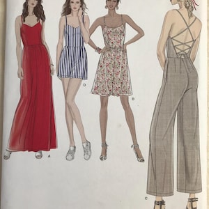 May include: Simplicity sewing pattern 8635 for sizes 6-14, featuring illustrations of four garment variations: a red maxi dress, a blue and white striped romper, a floral print knee-length dress, and a solid gray jumpsuit with a lace-up back.