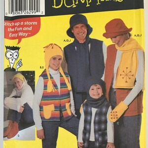 May include: A Simplicity 5744 sewing pattern envelope for fleece vests and accessories. The yellow packaging features illustrations of various fleece garments including vests, hats, scarves, and mittens in multiple colors and patterns for all ages.