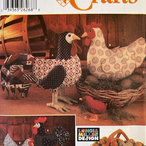 May include: A Simplicity Crafts sewing pattern envelope 5737 featuring instructions for fabric chickens, roosters, and chicks. The cover displays various stuffed poultry designs in patterned cotton fabrics, including a rooster, a hen on a nest, and small chicks, with a Longia Miller Design logo.