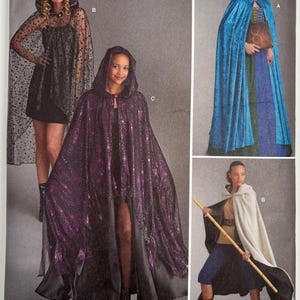 May include: Simplicity pattern 8721 for hooded capes in various styles. The package displays four variations: a sheer black polka-dot cape, a vibrant blue velvet cape, a purple metallic patterned cape, and a solid cream-colored hooded cape.