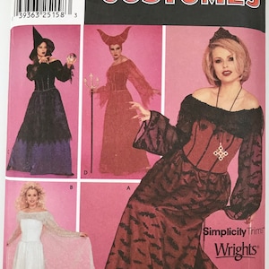 May include: A Simplicity Costumes sewing pattern envelope, number 9828, featuring four distinct costume designs. The package displays illustrations of various long dresses, including a black witch outfit, a red horned gown, and a white dress.