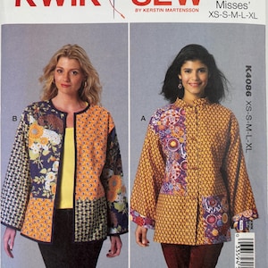 May include: A Kwik Sew K4086 sewing pattern envelope featuring two jacket styles. View B is a collarless jacket with floral and geometric panels. View A is a high-neck jacket with button closures and mixed patterned fabric panels in yellow and purple.