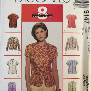 May include: McCall's 9147 sewing pattern envelope for size C (10, 12, 14) featuring 8 variations of a short-sleeved, mandarin-collar blouse. The cover displays a model wearing a red and yellow leaf-print blouse with various other shirt styles shown in illustrations labeled A through H.