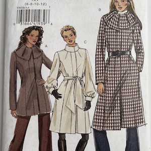 May include: Vogue V8438 sewing pattern envelope featuring illustrations of three coat styles. Style A is a brown jacket with a wide collar. Style C is a cream coat with a tie waist. Style B is a long houndstooth coat with a belt and large collar.