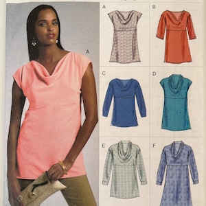 May include: A sewing pattern envelope with a woman wearing a pink top with a cowl neck. The envelope shows different top and tunic designs in various colors. The pattern number is V8816.